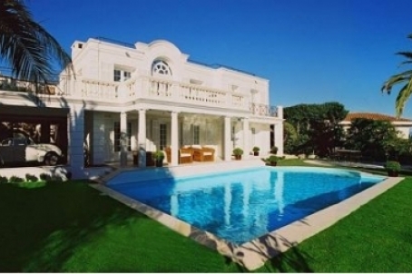 Luxury white villa with well-tended garden